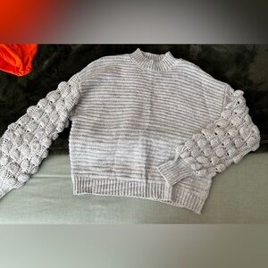 Grey sweater with bobble sleeve detail